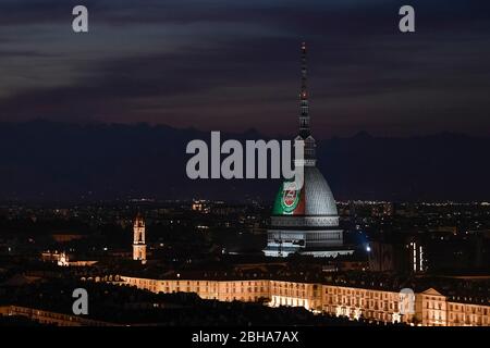 Turin, Italy. 24th Apr, 2020. TURIN, ITALY - April 24, 2020: The Mole Antonelliana, major landmark in Turin, is illuminated with the colors of the Italian national flag and the write '25 April' for the 75th anniversary of the liberation of Italy. April 25 is the Liberation Day (Festa della Liberazione) marking the Italy's liberation from nazis and fascists and the end of the Second World War (WWII) for Italy. The recurring torchlight procession and demonstration are not going to be celebrated due to the COVID19 restrictions. (Photo by Nicolò Campo/Sipa USA) Credit: Sipa USA/Alamy Live News Stock Photo