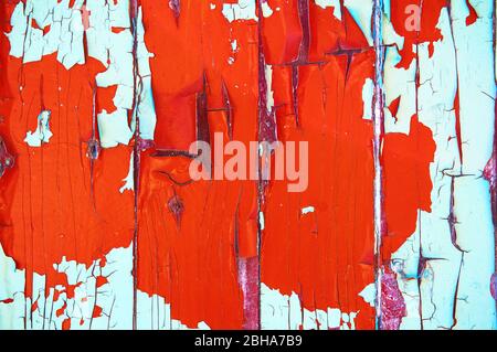 Old wooden board painted in green and red color with scratches and chips. Stock Photo