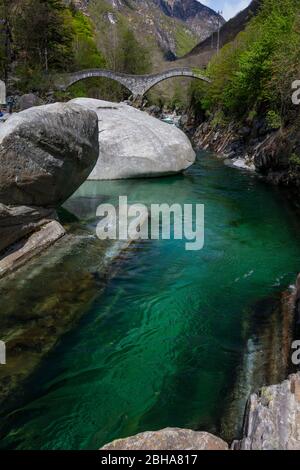 Switzerland, Ticino, Locarno, Verzasca Valley, Lavertezzo, Roman Bridge, Ponte Dei Salti, green water, smooth rocks Stock Photo