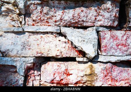 Wall of red brick close-up ruined. Abstract background. Stock Photo