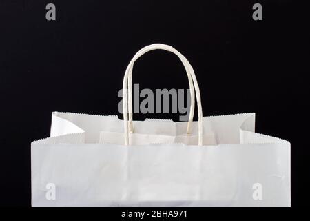 A white paper bag with holders on a black background Stock Photo