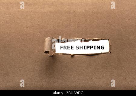 Torn Paper revealing Free Shipping message Stock Photo
