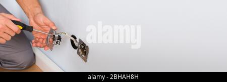 Electrician Installing Electric Socket Outlet In House Stock Photo