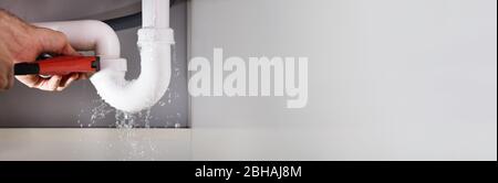 Broken Pipe Leak Fix And Water Leakage Stock Photo - Alamy