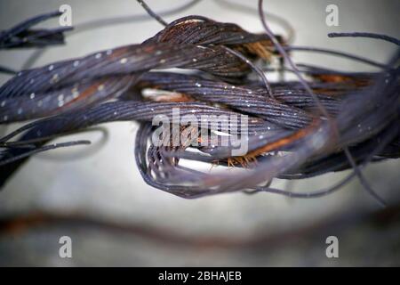 The shaky mesh and the wire of a chain link fence. Stock Photo