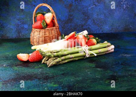 White and green fresh asparagus with a bunch of healthy strawberries Stock Photo