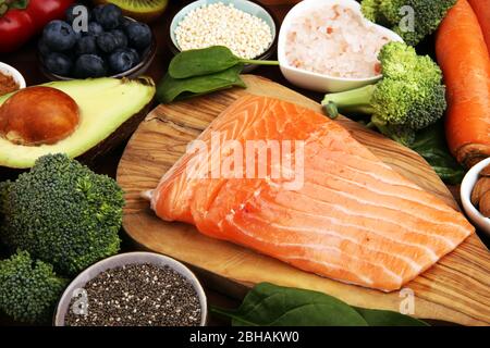 Healthy food clean eating selection: fish, fruit, vegetable, cereal, leaf vegetable on background Stock Photo