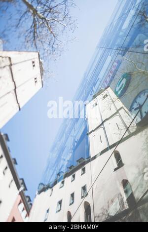 The tower of the Kölner Erzbistum general vicariate is reflected in the glass façade of the Cologne main station. Editorial use only. Stock Photo