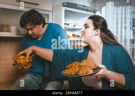 Body Positive Couple Overeating Of Unhealthy Food Stock Photo