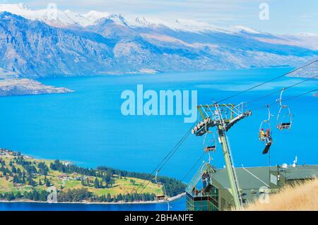 Luge riders taking lift up to top of hill, Queenstown, South Island, New Zealand, Stock Photo