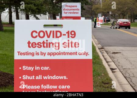 Dearborn, Michigan, USA. 24th Apr, 2020. Drive-though testing for the Covid-19 virus at a CVS Pharmacy test site. The site promises results in 15 minutes. Credit: Jim West/Alamy Live News Stock Photo