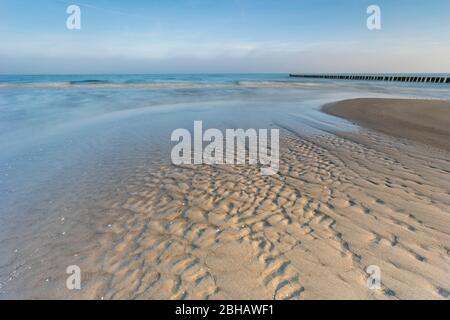 Sunrise in the winter by the sea with a falling mist of bright sun on a beautiful winter day Stock Photo