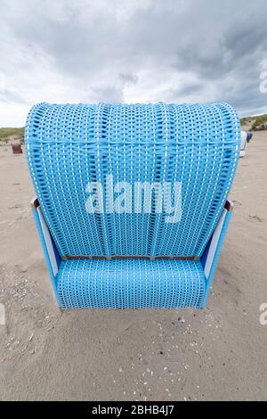 Germany, Lower Saxony, East Frisia, Juist, beach chair from behind, photographed with strong wide-angle. Stock Photo