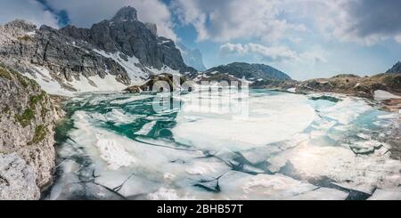 Coldai lake in spring with ice floating on the surface, Civetta mountain, Dolomites, Alleghe, Belluno, Veneto, Italy Stock Photo