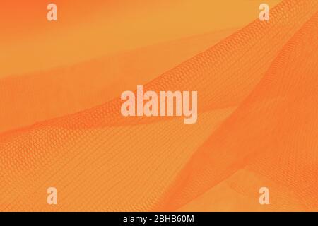 Small mesh fabric on orange background. Shades of orange color Stock Photo  - Alamy