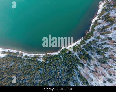Aerial view of vulcanic lake with snow in winter in Romania Stock Photo