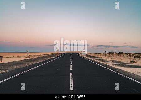 Beautiful road in the desert of Fuerteventura, Canary Islands at sunset Stock Photo