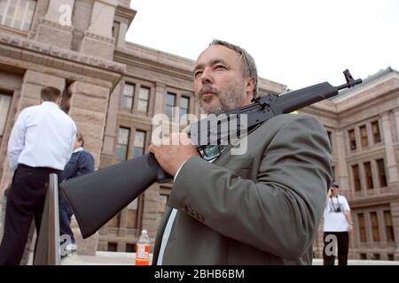 Austin, Texas USA, April 15 2010: A protestor holds an AK-47 assault rifle outside the Texas Capitol as Tea Party activists held their annual tax day rally. He said he was carrying a weapon in accordance with state law.  ©Marjorie Kamys Cotera /Daemmrich Photos Stock Photo