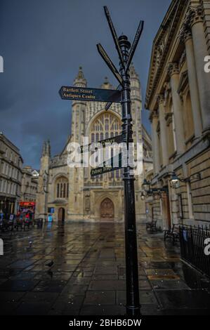 Black directional billboard in a desert square, indicating the monuments in Bath, England Stock Photo
