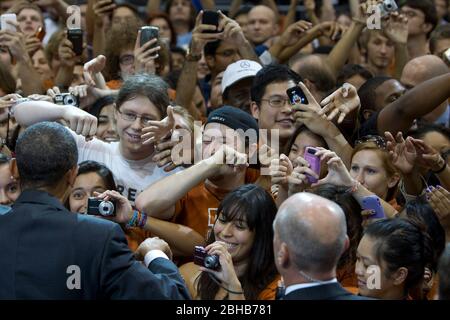 Austin Texas USA, August 9 2010: Excited audience members jostle for a handshake or cellphone photo as U.S. Pres. Barack Obama works the crowd after his speech at Gregory Gym at the University of Texas campus. ©Bob Daemmrich Stock Photo