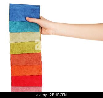 Female hand holding scraps of colored tissue isolated on white Stock Photo