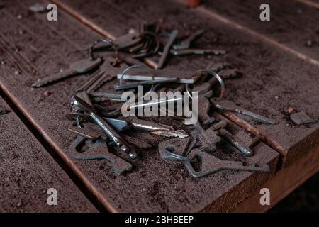 Pile of old rusty keys in dust. Stock Photo