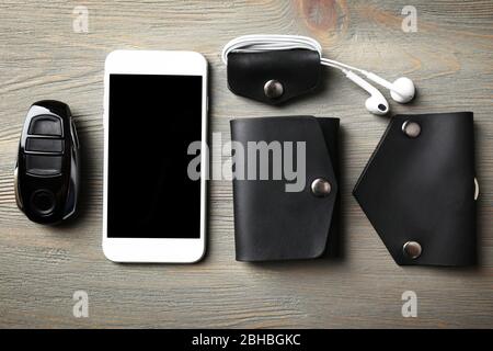 Hand made leather man accessories on white wooden background Stock Photo
