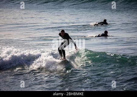 Australian man male surfing in a wetsuit off the Sydney coastline,NSW,Australia Stock Photo