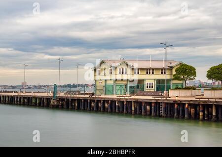 Long exposure of the Princess Pier over a cloudy dramatic at the port of Melbourne Stock Photo