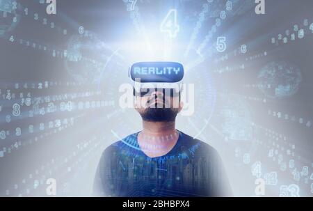 Young Guy in black t shirt wearing VR Virtual Reality glasses - Word Reality Stock Photo