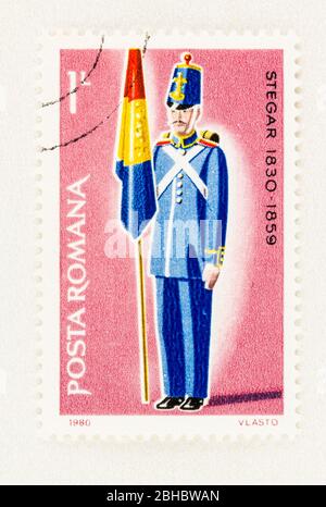 SEATTLE WASHINGTON - April 23, 2020: 1980 Romania  stamp  featuring flag bearer in military uniform.  Scott # 2980 Stock Photo