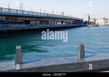Empty Galata Bridge over tranquil waters of Golden Horn and closed seafood restaurants under during Covid-19 Pandemic restrictions. Stock Photo