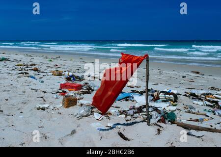 Plastic bottles and other rubbish thrown on the sandy seashore, trash on the sea beach. ecological problem. Environmental pollution. Dirty sandy beach Stock Photo
