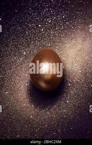 Golden egg and paint spray Galaxy. Abstract cosmos with golden egg planet. Stock Photo