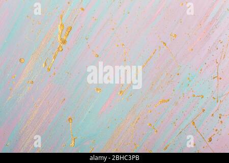 Golden drops and splashes. Hand painted background with wide strokes of blue and pink paint. Place for your design. Stock Photo
