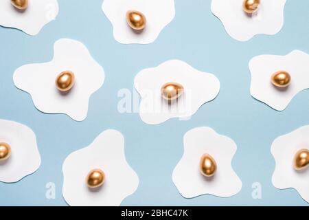 Creative layout made of fried eggs. Minimal pattern of paper protein and golden egg yolk. Creative easter concept. Stock Photo