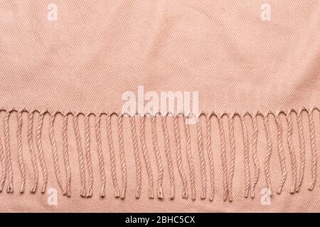 Pink plaid with tassels. Cozy soft fabric background with copy space. Stock Photo