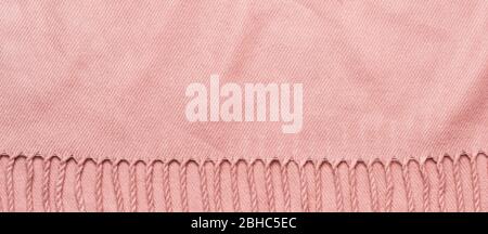 Pink plaid with tassels. Cozy soft fabric banner with copy space. Stock Photo