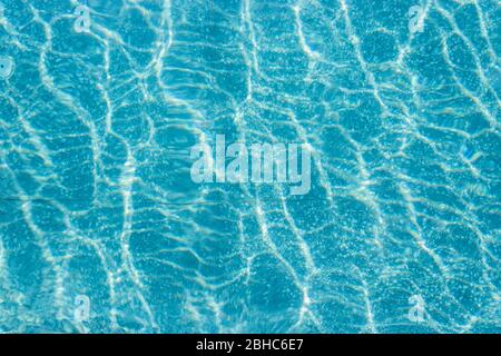 Abstract top view blue ripple swimming pool water and sun reflection caustics. Stock Photo
