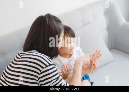 Mother and daughter paint their nails and have fun Stock Photo