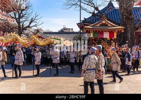 tokyo, japan - march 18 2020: Yatai cart overlooked in which sit the Matsuri-bayashi music musicians and the puppet masters holding the golden dragon Stock Photo