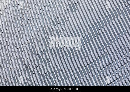 Skyscraper wall abstract background with repeated rectangular cells. Metal gray color with repetitive texture. Stock Photo
