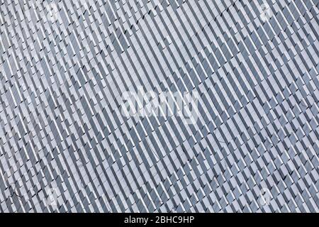 Skyscraper wall abstract background with repeated rectangular cells. Metal gray color with repetitive texture. Stock Photo