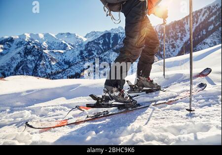 Man skiing on fresh powder snow at the mountains close up shot, low angle. Stock Photo