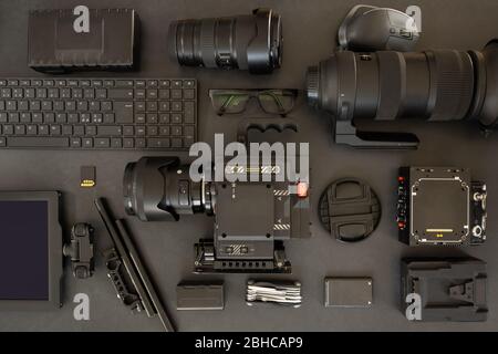 Flat lay of filming equipment with keyboard and eyeglasses on table Stock Photo