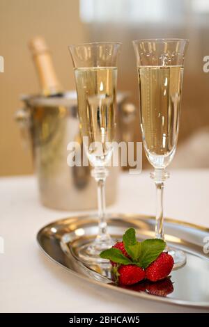 Bottle of champagne, two glasses and strawberries on sea and sky  background. Summer holiday and romantic party concept Stock Photo - Alamy
