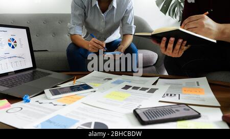 Business people writing on sticky notes for colleagues thinking strategy business plan or over problem in coworking office, Diverse Brainstorm Busines Stock Photo