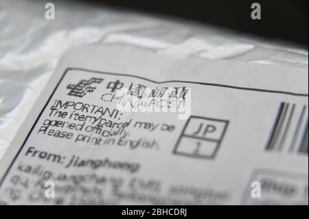 Fuji City, Shizuoka Prefecture, Japan - March 22, 2020: Bubble wrap padded envelope with close- up on China Post label. Isolated on black background. Stock Photo