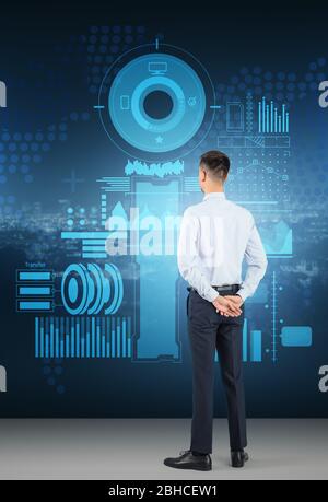 Businessman using virtual screen on dark background. Concept of business data Stock Photo