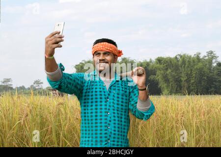 farmer taking selfie with his phone at field Stock Photo